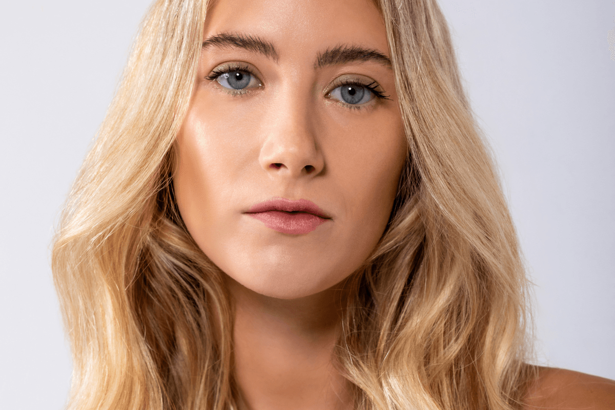 Model with hydrated glowing skin after using REMAKE skincare