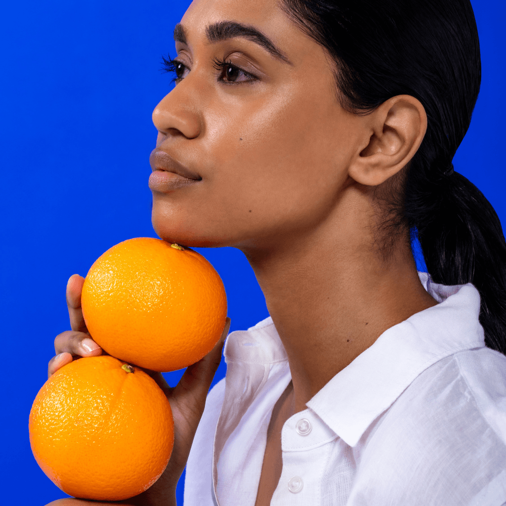 Vitamin C Skincare Ingredient. Model holding oranges for SKIN OJ: Antioxidant Moisturiser - REMAKE