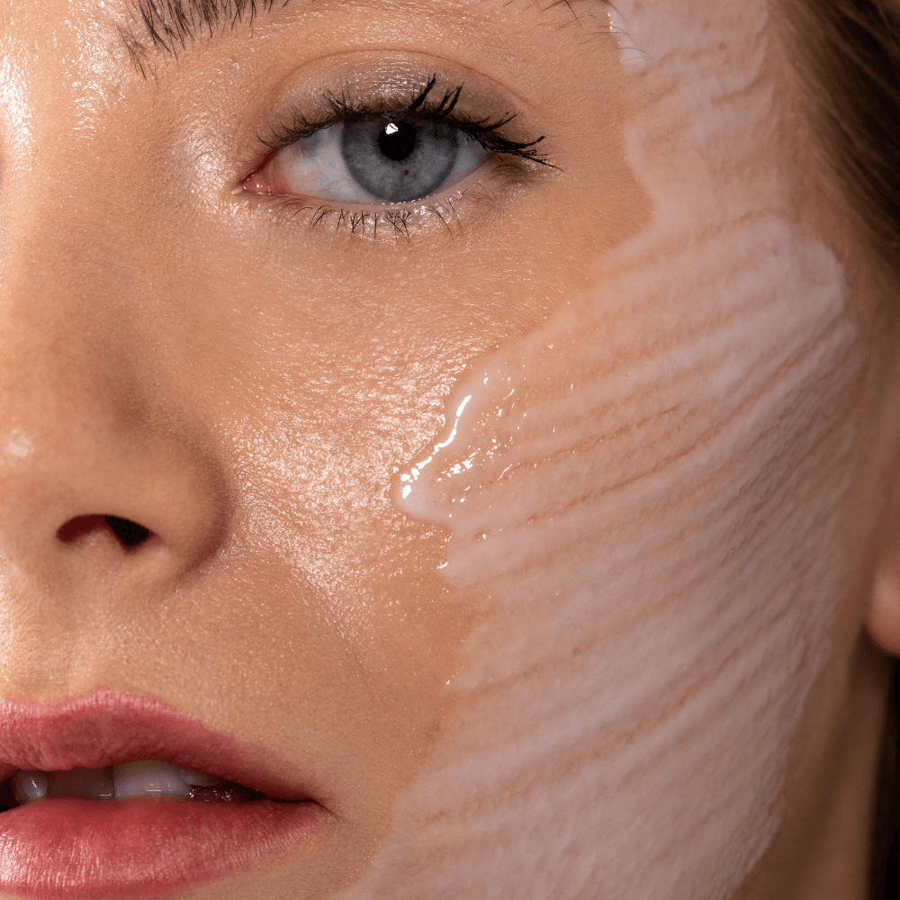 Close-up model with moisturiser swatch on face, Skin OJ&