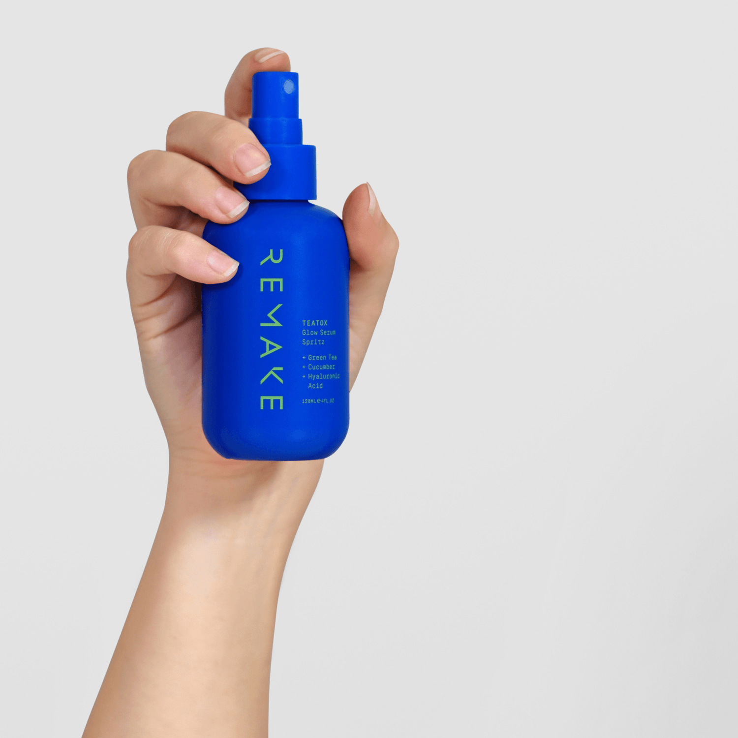 Hand holding sustainable skincare brand product TEATOX: Glow Serum Spritz - REMAKE