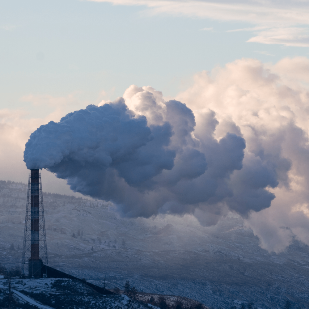 Thick smoke pollution rising from large industrial chimney, symbol of climate change and air pollution